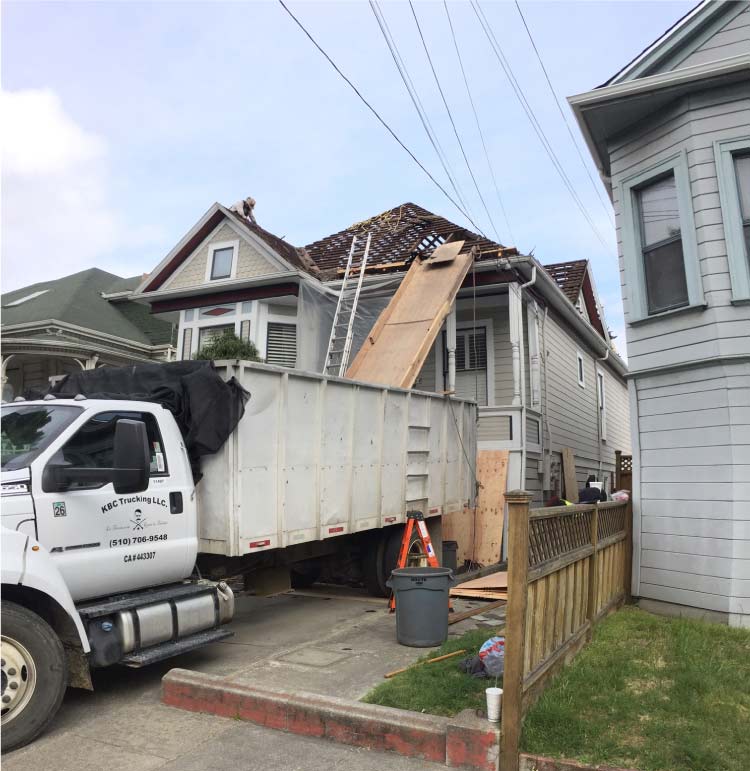 Astro Roofers in san leandro installing a new roof and downspouts on a home in san leandro, california