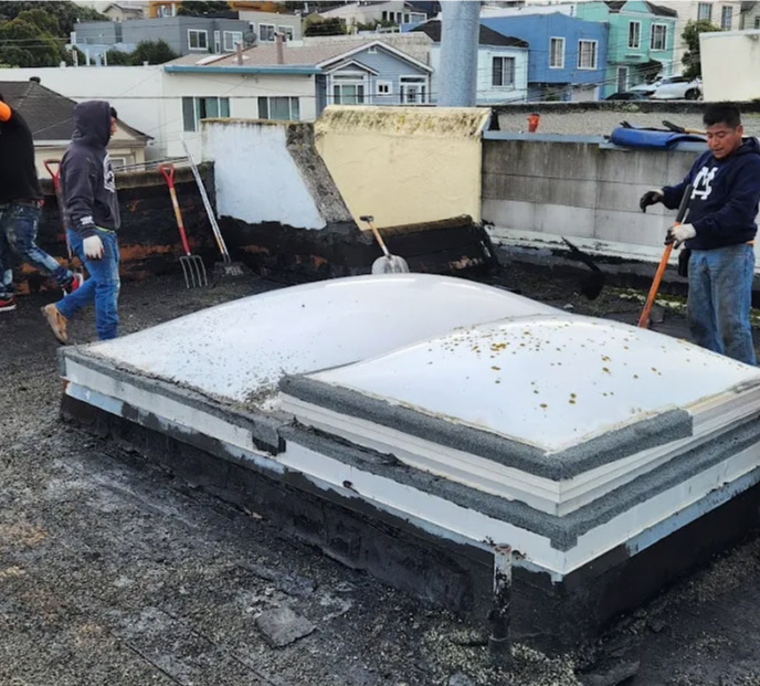 Professional general manager Dario Urizar-Jimenez supervising flat roof repair work on a property in Alameda, CA.