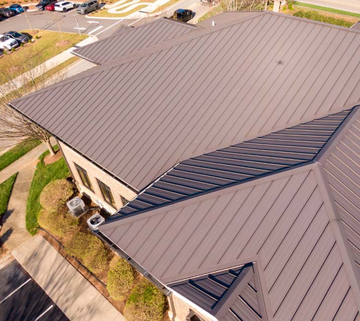 aerial view of residential house with metal roof