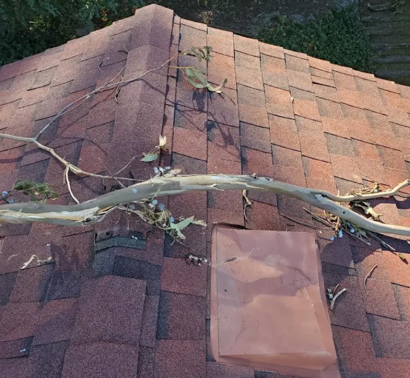 alt="Astro Roofing service van parked beside a newly installed gray asphalt shingle roof in Oakland, CA"